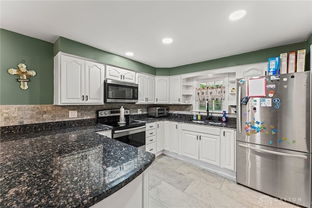 1012 W Sparrow Rd, Springfield, OH 45502 - kitchen featuring stainless steel appliances, a sink, white cabinetry, dark stone countertops, and recessed lighting