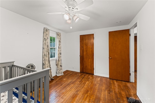 1012 W Sparrow Rd, Springfield, OH 45502 - unfurnished bedroom featuring wood-type flooring, baseboards, and ceiling fan