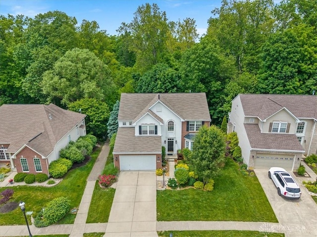1422 Shawnee Run Dr, Maineville, OH 45039 - view of front facade featuring driveway, a garage, and a front lawn