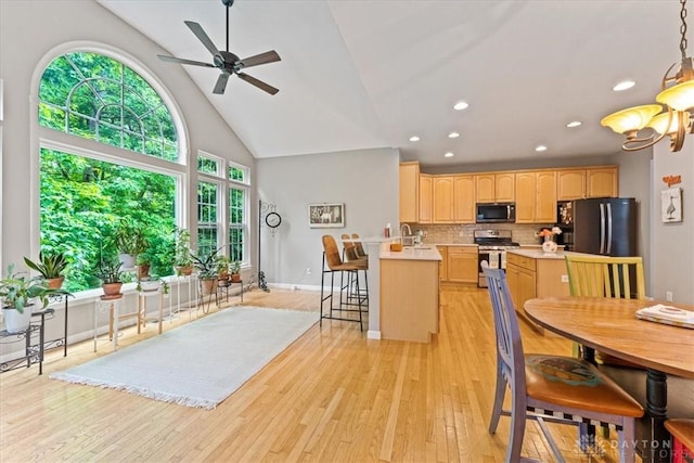 1422 Shawnee Run Dr, Maineville, OH 45039 - kitchen with stainless steel appliances, light brown cabinetry, light countertops, recessed lighting, and a peninsula