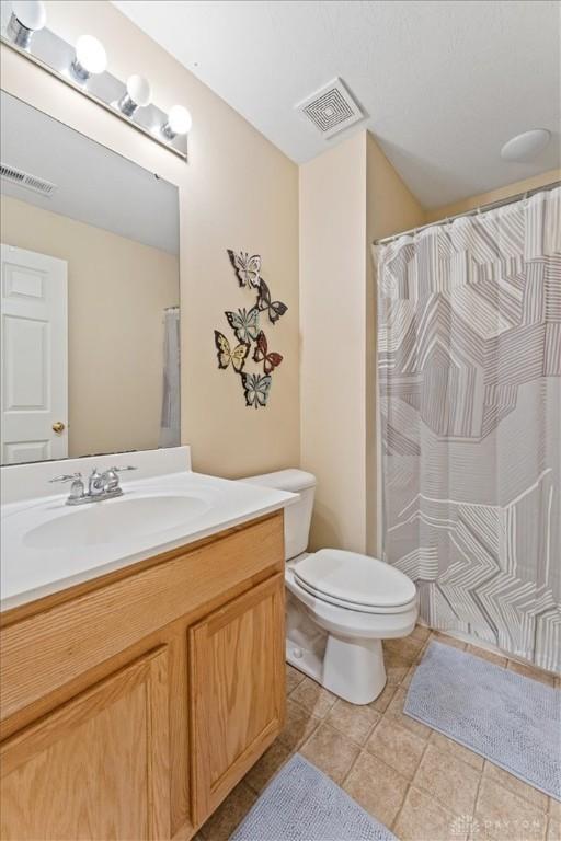 1422 Shawnee Run Dr, Maineville, OH 45039 - bathroom with toilet, vanity, tile patterned flooring, and curtained shower