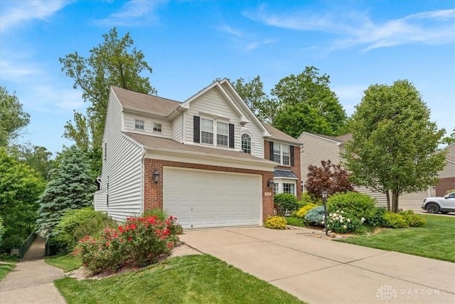1422 Shawnee Run Dr, Maineville, OH 45039 - traditional-style home with brick siding, an attached garage, concrete driveway, and a front yard