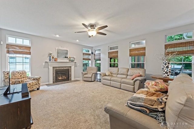 1422 Shawnee Run Dr, Maineville, OH 45039 - living area with ceiling fan, carpet floors, a fireplace with flush hearth, and baseboards