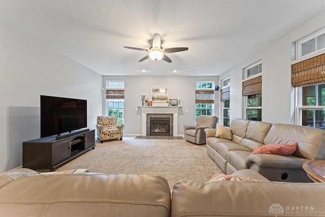 1422 Shawnee Run Dr, Maineville, OH 45039 - living area with a ceiling fan, a tiled fireplace, and carpet flooring