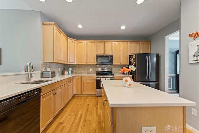 1422 Shawnee Run Dr, Maineville, OH 45039 - kitchen with black appliances, light brown cabinets, a sink, a kitchen island, and recessed lighting