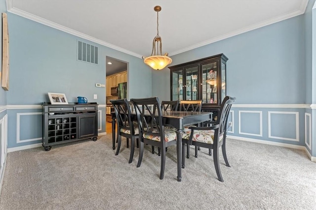 1422 Shawnee Run Dr, Maineville, OH 45039 - dining space with light colored carpet, crown molding, wainscoting, and a decorative wall