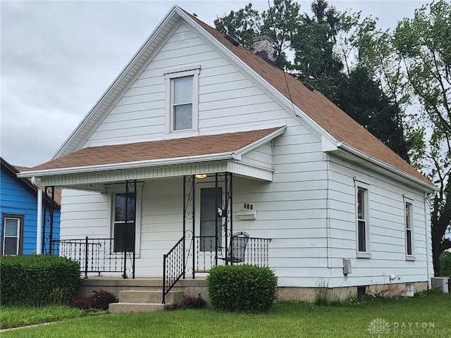 211 Nordale Ave, Dayton, OH 45420 - view of front of property featuring a chimney, a porch, a shingled roof, and a front yard