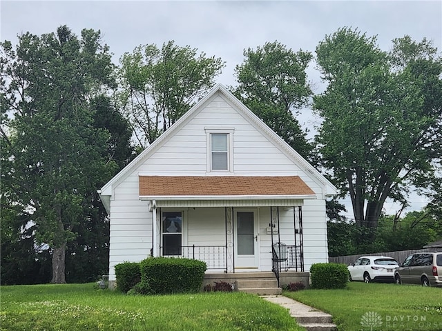 211 Nordale Ave, Dayton, OH 45420 - bungalow-style home with covered porch and a front lawn