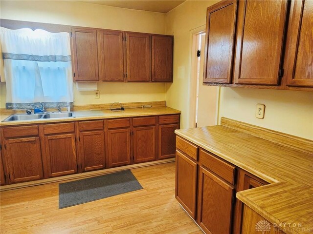 211 Nordale Ave, Dayton, OH 45420 - kitchen featuring a sink, light countertops, and light wood finished floors
