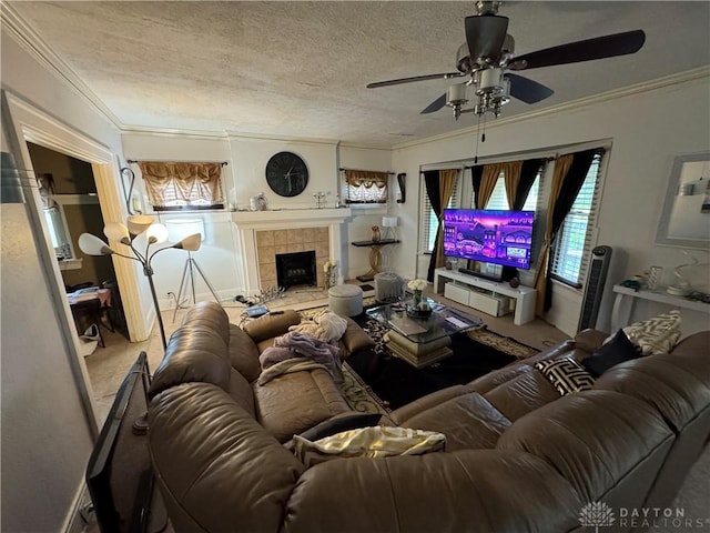1606 W Grand Ave, Dayton, OH 45402 - carpeted living area featuring a ceiling fan, ornamental molding, plenty of natural light, a textured ceiling, and a tiled fireplace