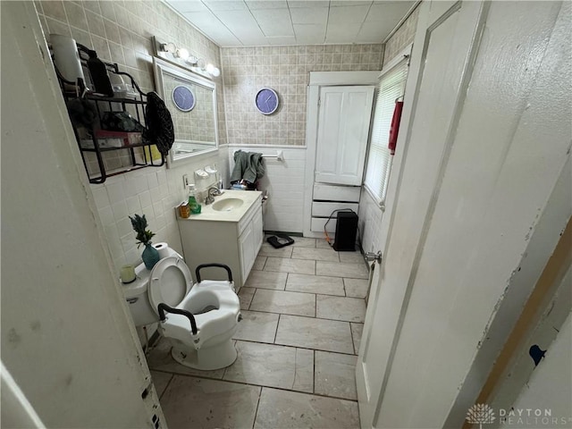 1606 W Grand Ave, Dayton, OH 45402 - bathroom with tile walls, vanity, and toilet