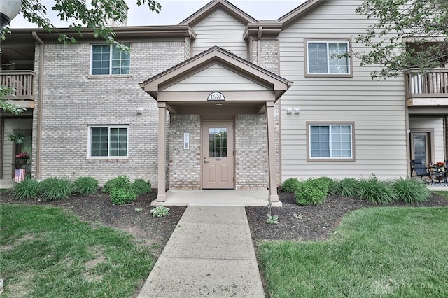 1690 Piper Ln Unit 206, Washington Twp, OH 45440 - view of front of house with brick siding, a front yard, and a balcony