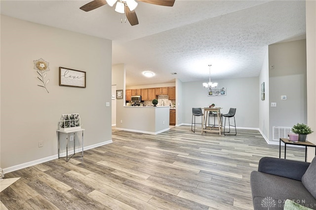 1690 Piper Ln Unit 206, Washington Twp, OH 45440 - living area with ceiling fan, light wood-style flooring, a chandelier, lofted ceiling, and baseboards