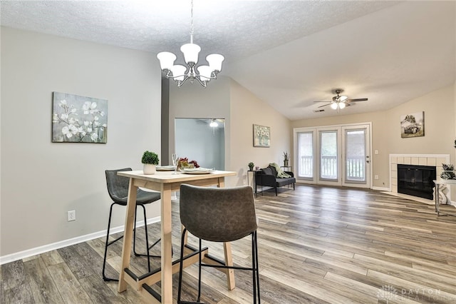 1690 Piper Ln Unit 206, Washington Twp, OH 45440 - dining room featuring ceiling fan, a textured ceiling, light wood-style flooring, vaulted ceiling, and a chandelier