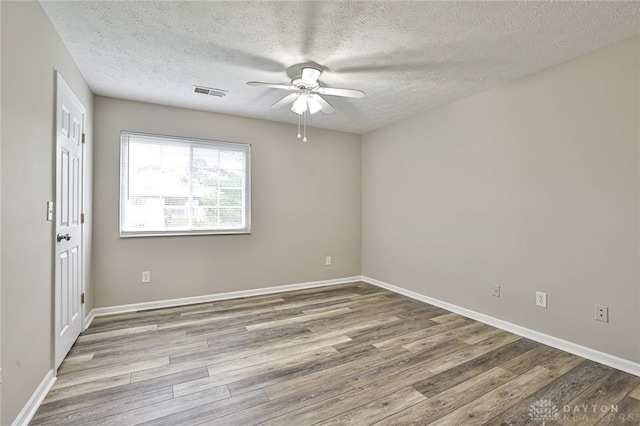 1690 Piper Ln Unit 206, Washington Twp, OH 45440 - spare room featuring wood finished floors, a ceiling fan, a textured ceiling, and baseboards