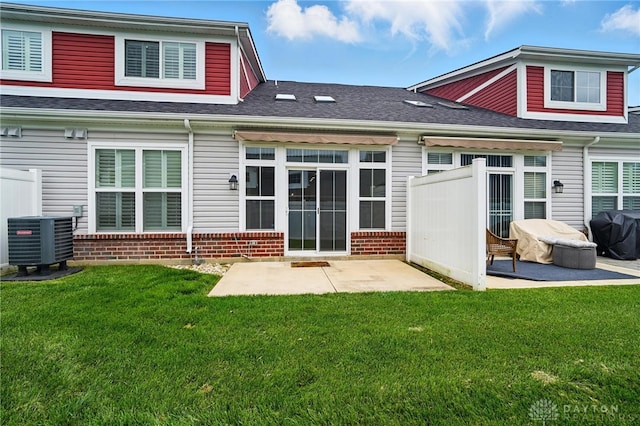 641 Angler Ct, Beavercreek, OH 45430 - back of property featuring central AC, a patio area, brick siding, and a lawn
