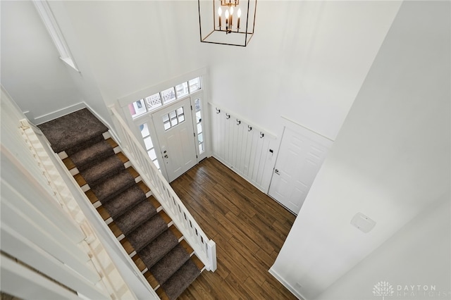 641 Angler Ct, Beavercreek, OH 45430 - foyer entrance featuring dark wood-style floors, a high ceiling, a chandelier, stairs, and baseboards