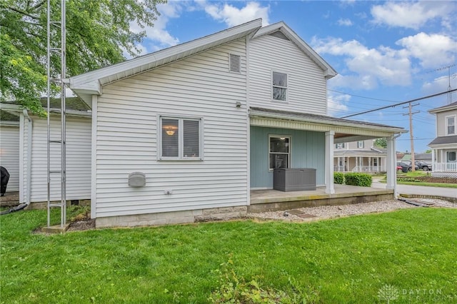 107 S High St, Arcanum, OH 45304 - view of front facade featuring covered porch and a front lawn