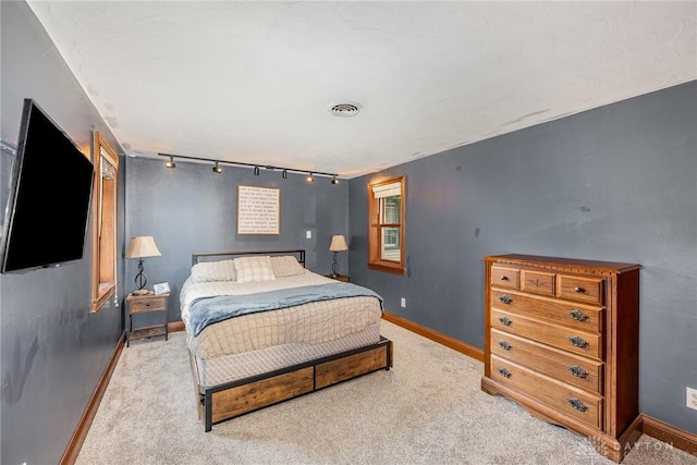 107 S High St, Arcanum, OH 45304 - bedroom with rail lighting, light carpet, and baseboards