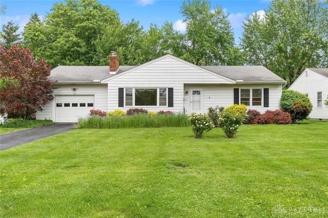 357 E Vine St, Wilmington, OH 45177 - single story home featuring a garage, driveway, a chimney, and a front yard