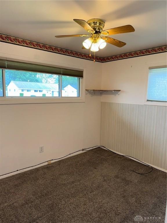 409 Skyview Dr, Vandalia, OH 45377 - spare room with dark carpet and a ceiling fan