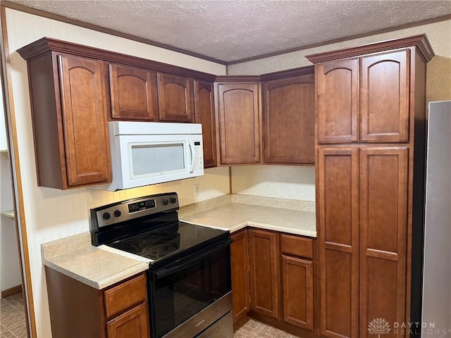 409 Skyview Dr, Vandalia, OH 45377 - kitchen featuring white microwave, stainless steel electric range oven, light countertops, and a textured ceiling