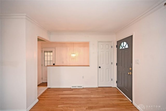 1525 Forrer Blvd, Kettering, OH 45420 - foyer entrance with light wood finished floors, crown molding, and baseboards