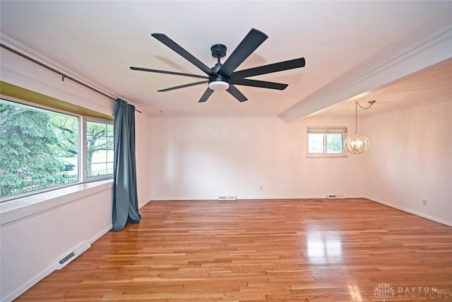 1525 Forrer Blvd, Kettering, OH 45420 - empty room featuring ceiling fan, light wood finished floors, crown molding, a chandelier, and baseboards