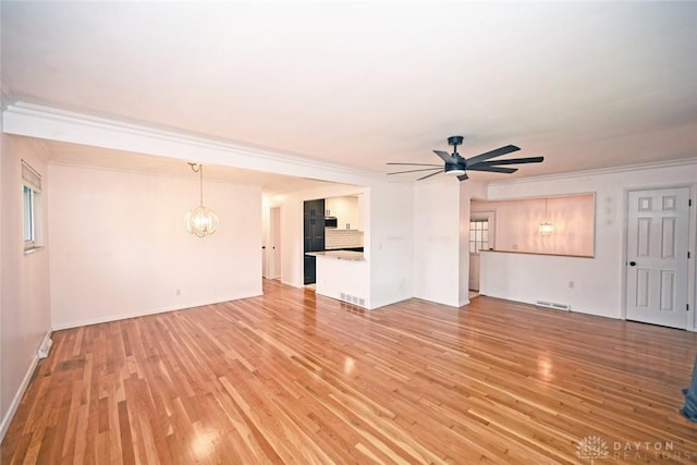 1525 Forrer Blvd, Kettering, OH 45420 - unfurnished living room with light wood-style flooring, a ceiling fan, a chandelier, ornamental molding, and baseboards