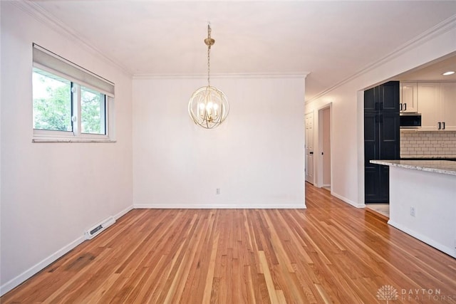 1525 Forrer Blvd, Kettering, OH 45420 - unfurnished dining area featuring light wood-style flooring, a chandelier, crown molding, and baseboards