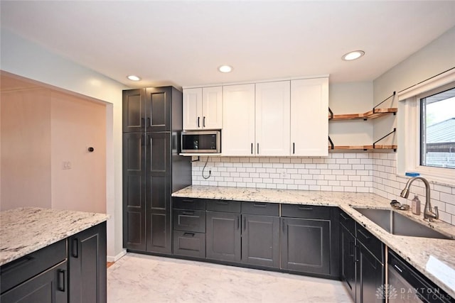 1525 Forrer Blvd, Kettering, OH 45420 - kitchen featuring appliances with stainless steel finishes, a sink, white cabinets, recessed lighting, and light stone countertops