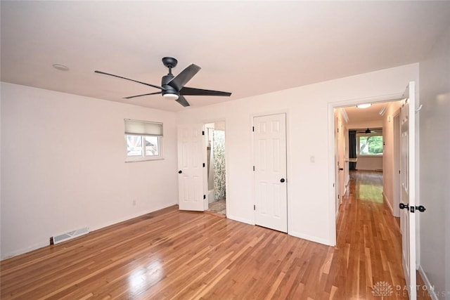 1525 Forrer Blvd, Kettering, OH 45420 - unfurnished bedroom featuring light wood-type flooring, baseboards, ceiling fan, and ensuite bath