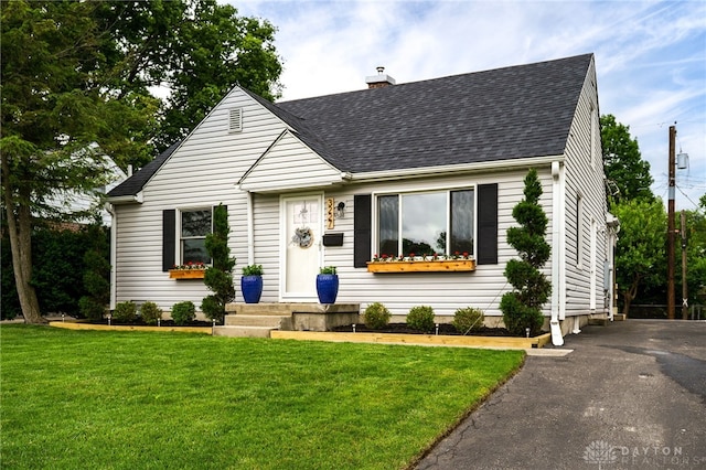 3227 Mirimar St, Dayton, OH 45409 - cape cod house with a chimney, roof with shingles, and a front yard