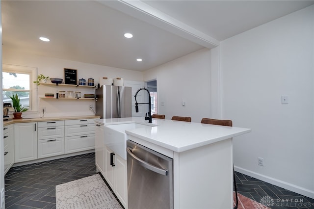 3227 Mirimar St, Dayton, OH 45409 - kitchen featuring appliances with stainless steel finishes, white cabinetry, a center island with sink, recessed lighting, and a sink