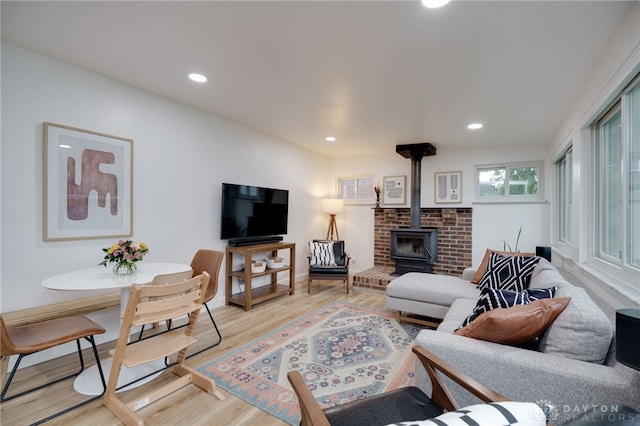 3227 Mirimar St, Dayton, OH 45409 - living area with a wood stove, light wood-style flooring, recessed lighting, and baseboards