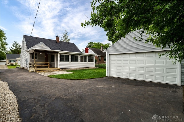 3227 Mirimar St, Dayton, OH 45409 - rear view of property with an outdoor structure, a chimney, a lawn, and a deck