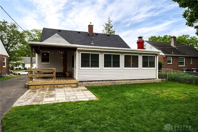 3227 Mirimar St, Dayton, OH 45409 - rear view of house featuring a chimney, a wooden deck, a shingled roof, and a patio