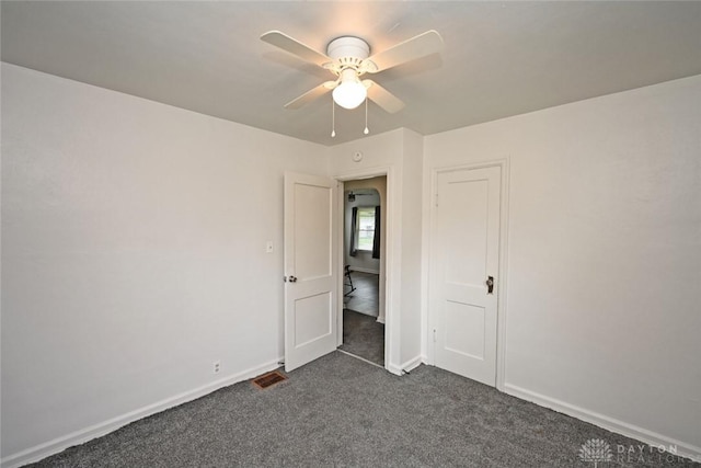 932 Crestmore Ave, Dayton, OH 45402 - unfurnished bedroom featuring dark colored carpet, baseboards, and a ceiling fan