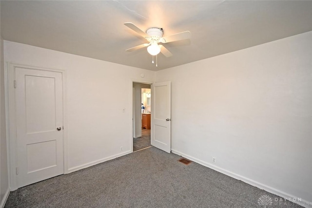 932 Crestmore Ave, Dayton, OH 45402 - unfurnished bedroom with dark colored carpet, baseboards, and a ceiling fan