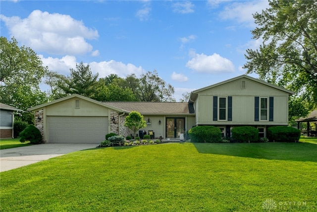 2155 Shenandoah Dr, Troy, OH 45373 - tri-level home featuring a garage, driveway, a front lawn, and french doors