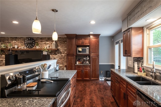 2155 Shenandoah Dr, Troy, OH 45373 - kitchen featuring stainless steel appliances, dark wood-style floors, a sink, decorative light fixtures, and light stone countertops