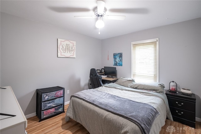 2155 Shenandoah Dr, Troy, OH 45373 - bedroom featuring light wood-style flooring, a ceiling fan, baseboards, and a desk