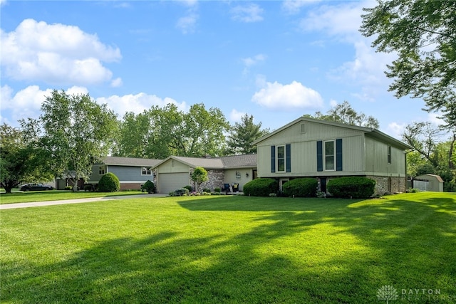 2155 Shenandoah Dr, Troy, OH 45373 - split level home with concrete driveway, a garage, a front yard, and stone siding