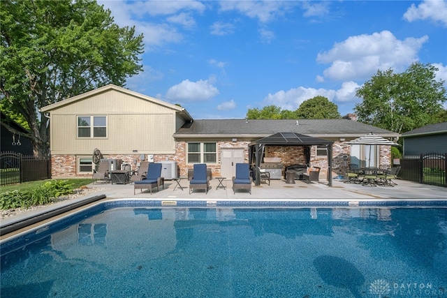 2155 Shenandoah Dr, Troy, OH 45373 - rear view of house featuring a gazebo, a patio area, and brick siding