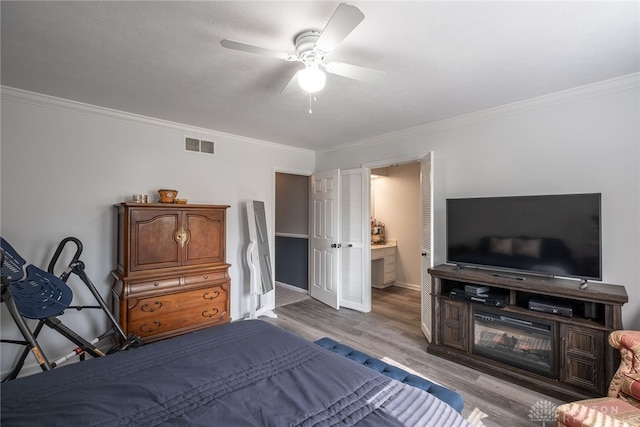 2155 Shenandoah Dr, Troy, OH 45373 - bedroom featuring crown molding, wood finished floors, baseboards, ceiling fan, and connected bathroom