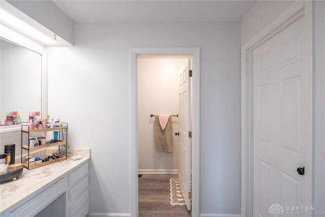2155 Shenandoah Dr, Troy, OH 45373 - bathroom featuring vanity, wood finished floors, and baseboards