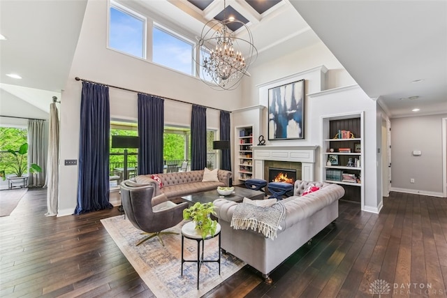 3886 Hudson Hills Ln, Mason, OH 45040 - living room with baseboards, a lit fireplace, a chandelier, dark wood-style floors, and a towering ceiling