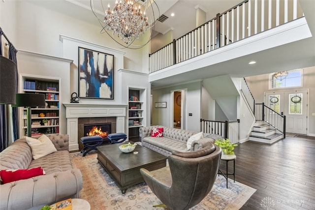 3886 Hudson Hills Ln, Mason, OH 45040 - living area featuring a chandelier, a towering ceiling, stairway, hardwood / wood-style floors, and built in features