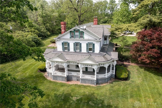 5894 Hamilton Lebanon Rd, Monroe, OH 45044 - view of front facade featuring a chimney, a porch, a front yard, and a shingled roof