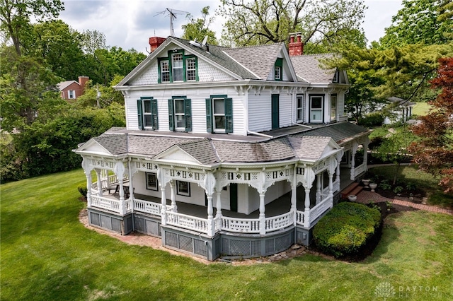 5894 Hamilton Lebanon Rd, Monroe, OH 45044 - back of property featuring a chimney, covered porch, a shingled roof, and a lawn